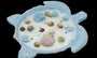 Decorative turtle shell candle with seashells and pearls