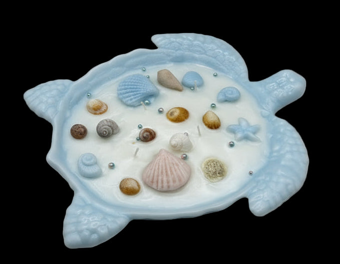 Decorative turtle shell candle with seashells and pearls