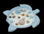 Decorative turtle shell candle with seashells and pearls