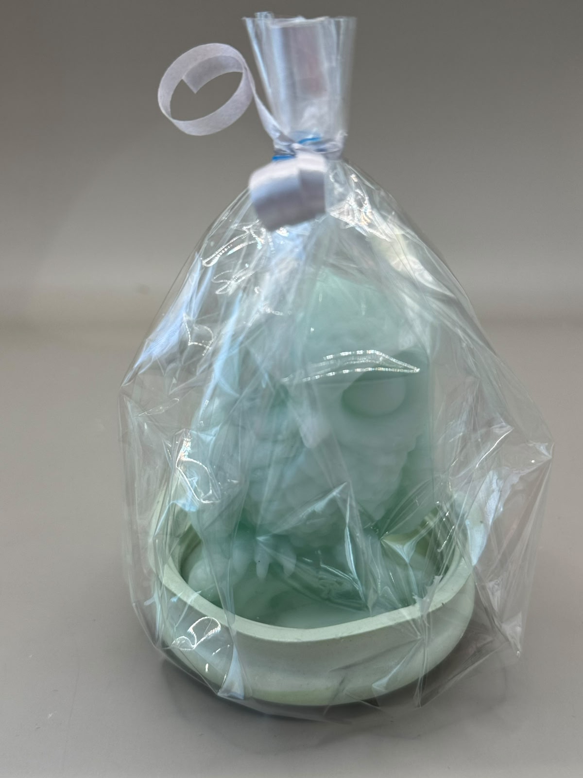 Single Owl scented candle on ceramic footpiece